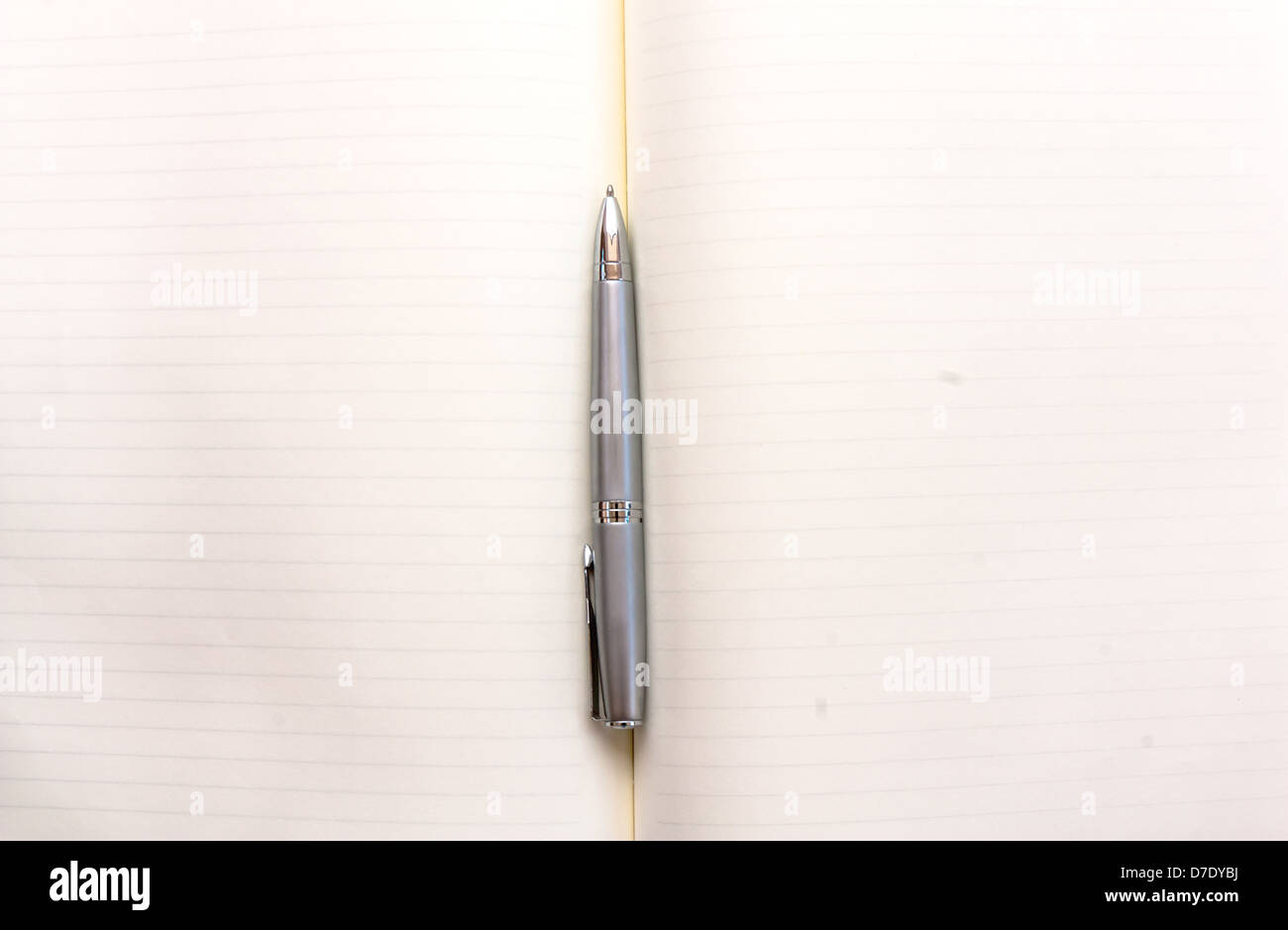 Opened notebook with blank pages and a pen Stock Photo