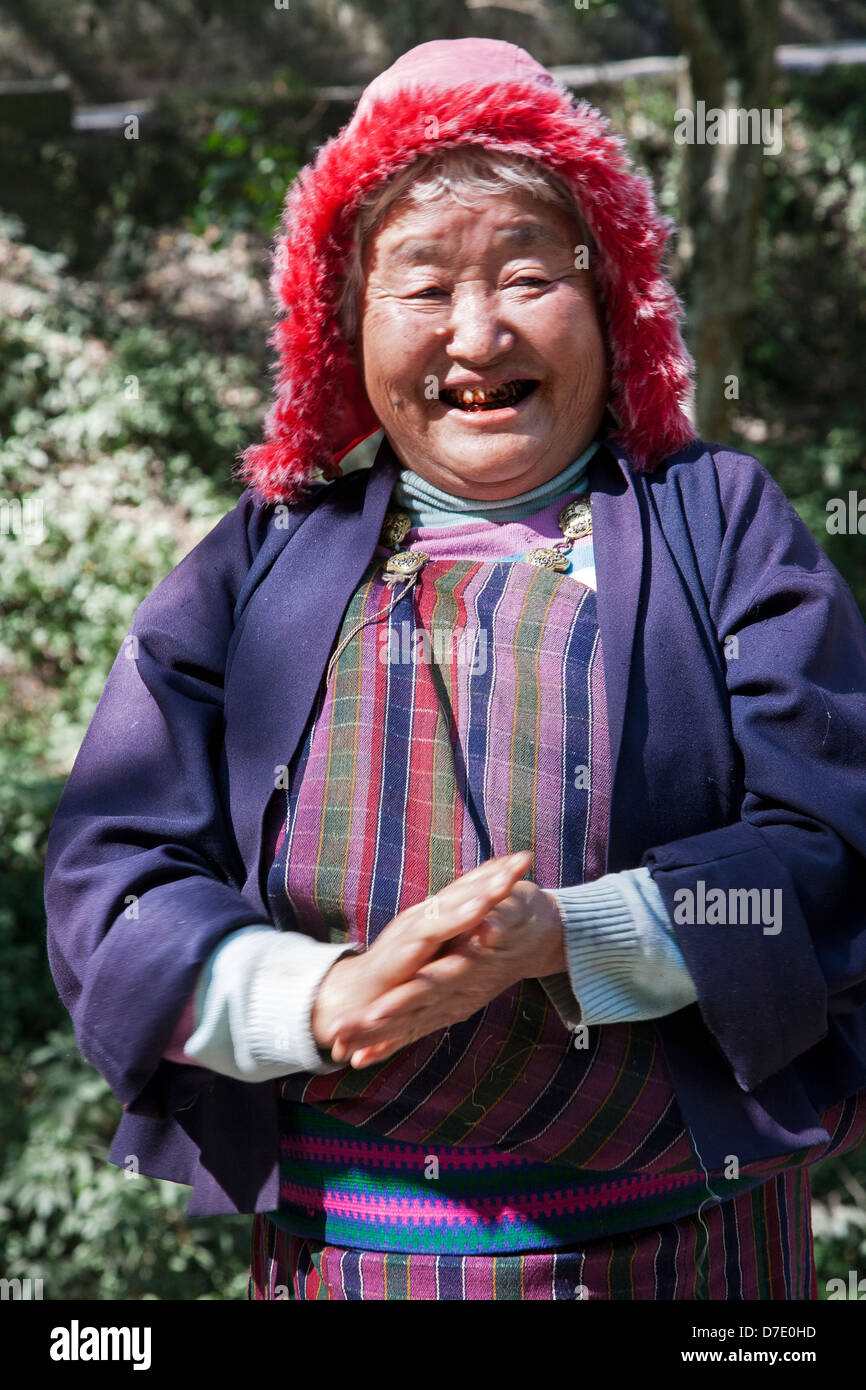 A woman flashes a smile with teeth stained from chewing betel nut, a favorite habit in Bhutan. Stock Photo