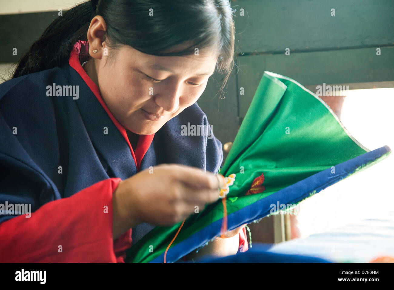 A teen girl practices embroidery at the art school in Thimphu, Bhutan. Stock Photo