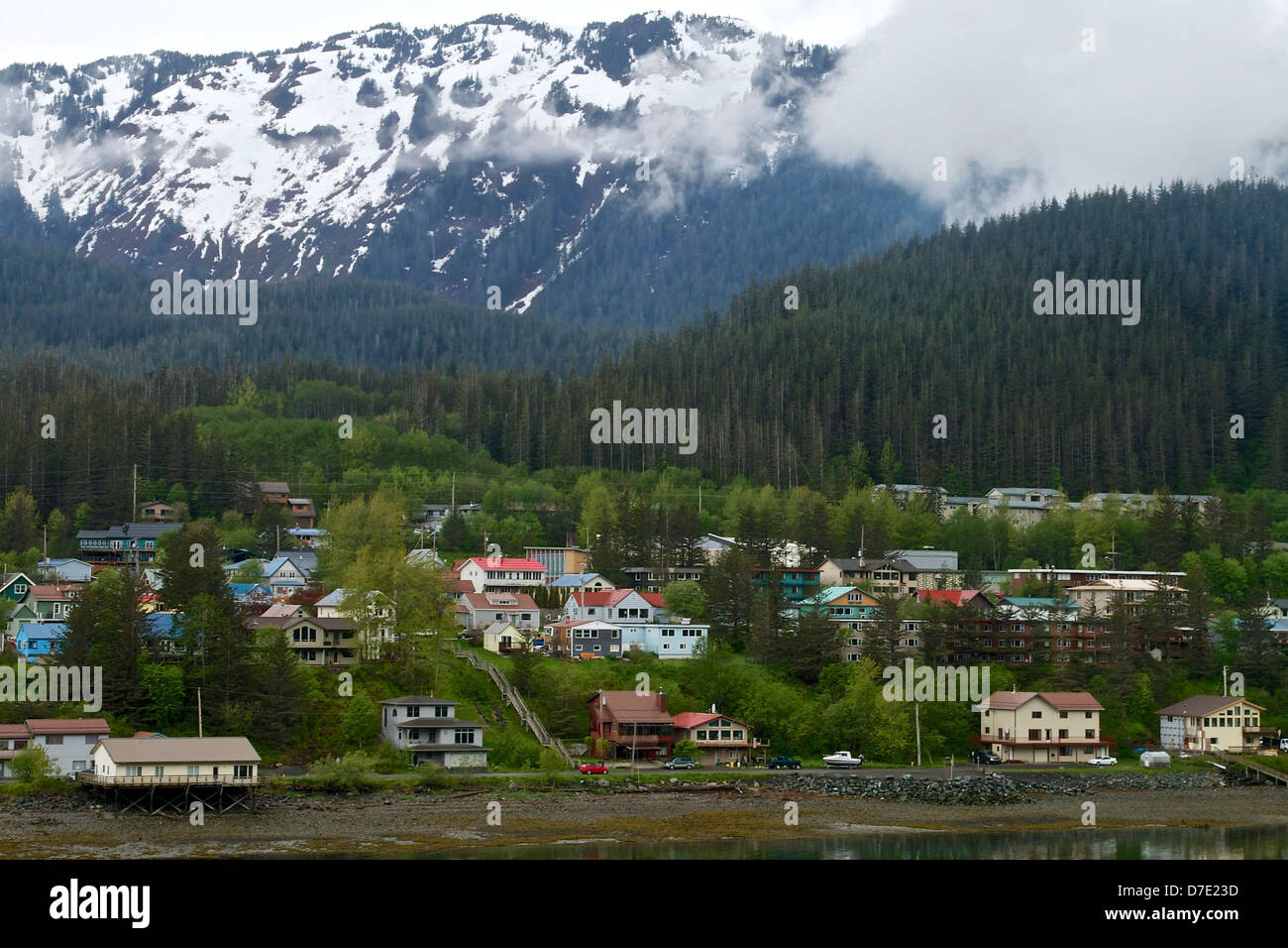 Small Village In Alaska With Snow Covered Mountains And Clouds Stock Photo Alamy