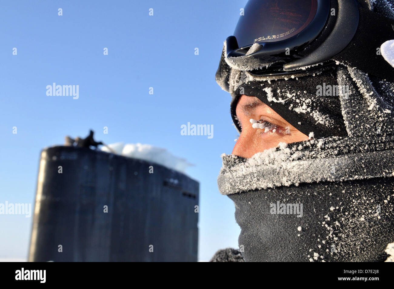A US Navy sailor aboard the Los Angeles-class nuclear attack submarine USS Annapolis keeps watch from the bridge after breaking through three feet of ice while participating Ice Exercise March 21, 2009 in the Arctic Ocean. Two Los Angeles-class submarines, USS Helena and USS Annapolis are participating in the exercise with researchers from the University of Washington Applied Physics Laboratory and personnel from the Navy Arctic Submarine Laboratory. Stock Photo