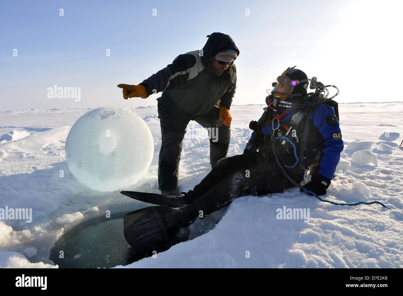 Paul Aguilar, of the University of Washington Applied Physics Laboratory works with Pete Pehl, a member of the Applied Physics Laboratory dive team to recover a torpedo from under the ice while participating with the US Navy Los Angeles-class nuclear attack submarine USS Annapolis in Ice Exercise March 21, 2009 in the Arctic Ocean. Stock Photo