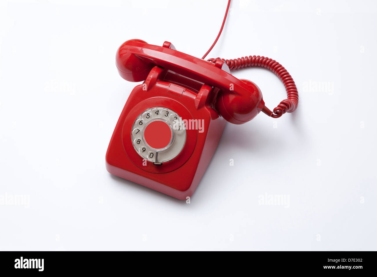 A red telephone receiver, original 1960's dial phone. Stock Photo