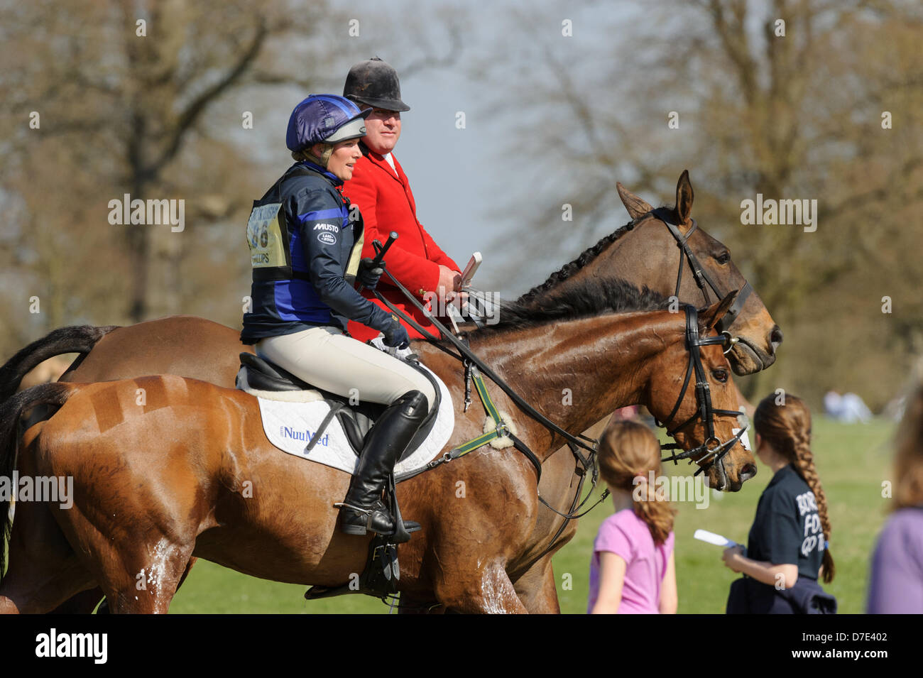 Badminton Horse Trials, UK. 5th May, 2013. Zara Phillips is escorted back to the stables by a Huntsman after retiring from the cross country phase of the Mitsubishi Motors Badminton Horse Trials, Sunday May 5th 2013 Stock Photo