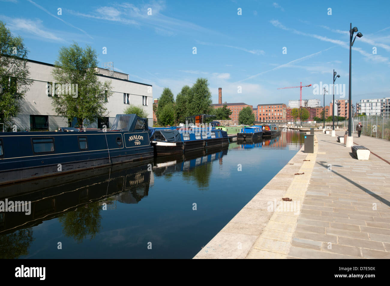 Canal narrowboats reflected in the Cotton Field Park marina, New Islington, Ancoats, Manchester, England, UK Stock Photo