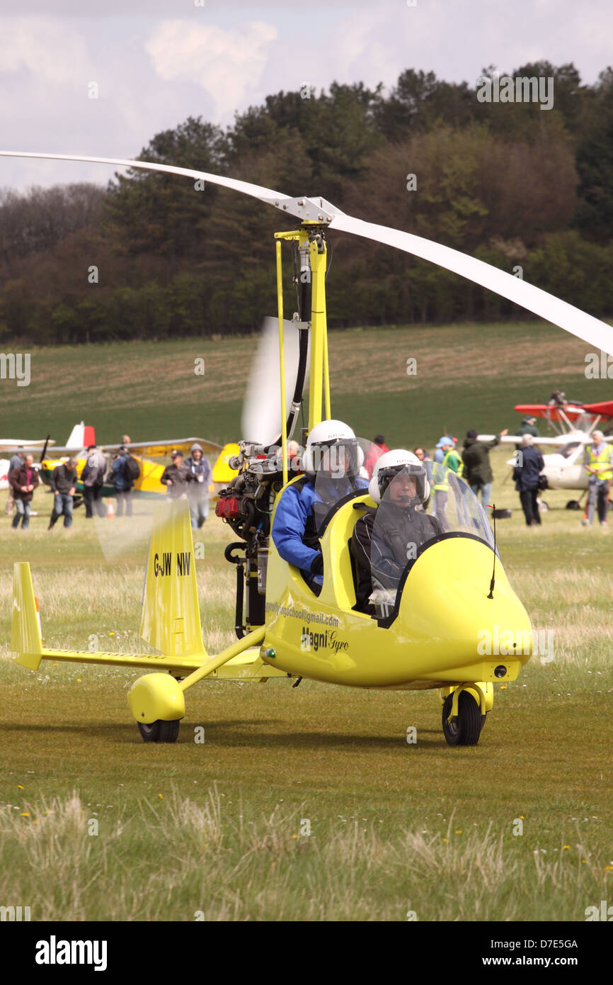 Gyrocopter gyro Magni M16 Tandem Trainer pilot and passenger taxy at Popham airfield UK Stock Photo