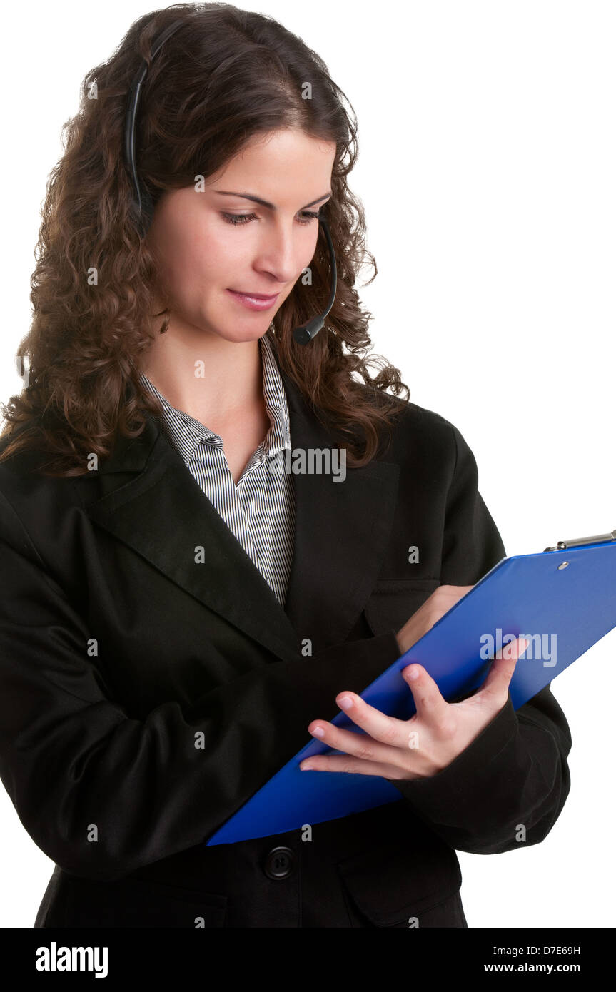 Corporate woman talking over her headset, holding a pad, isolated in a white background Stock Photo
