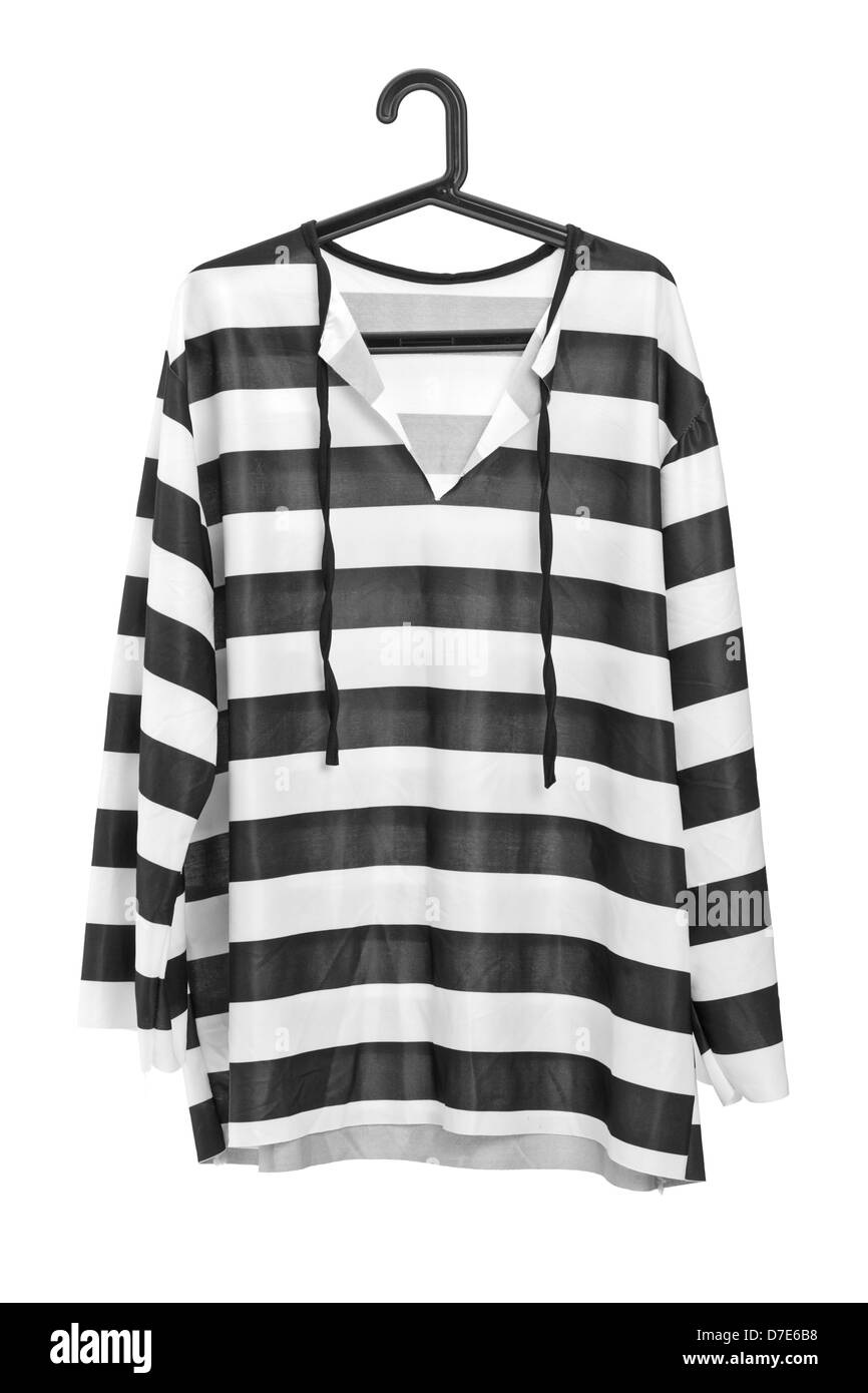 A studio shot of a black and white striped prison uniform on a hanger isolated against white background Stock Photo