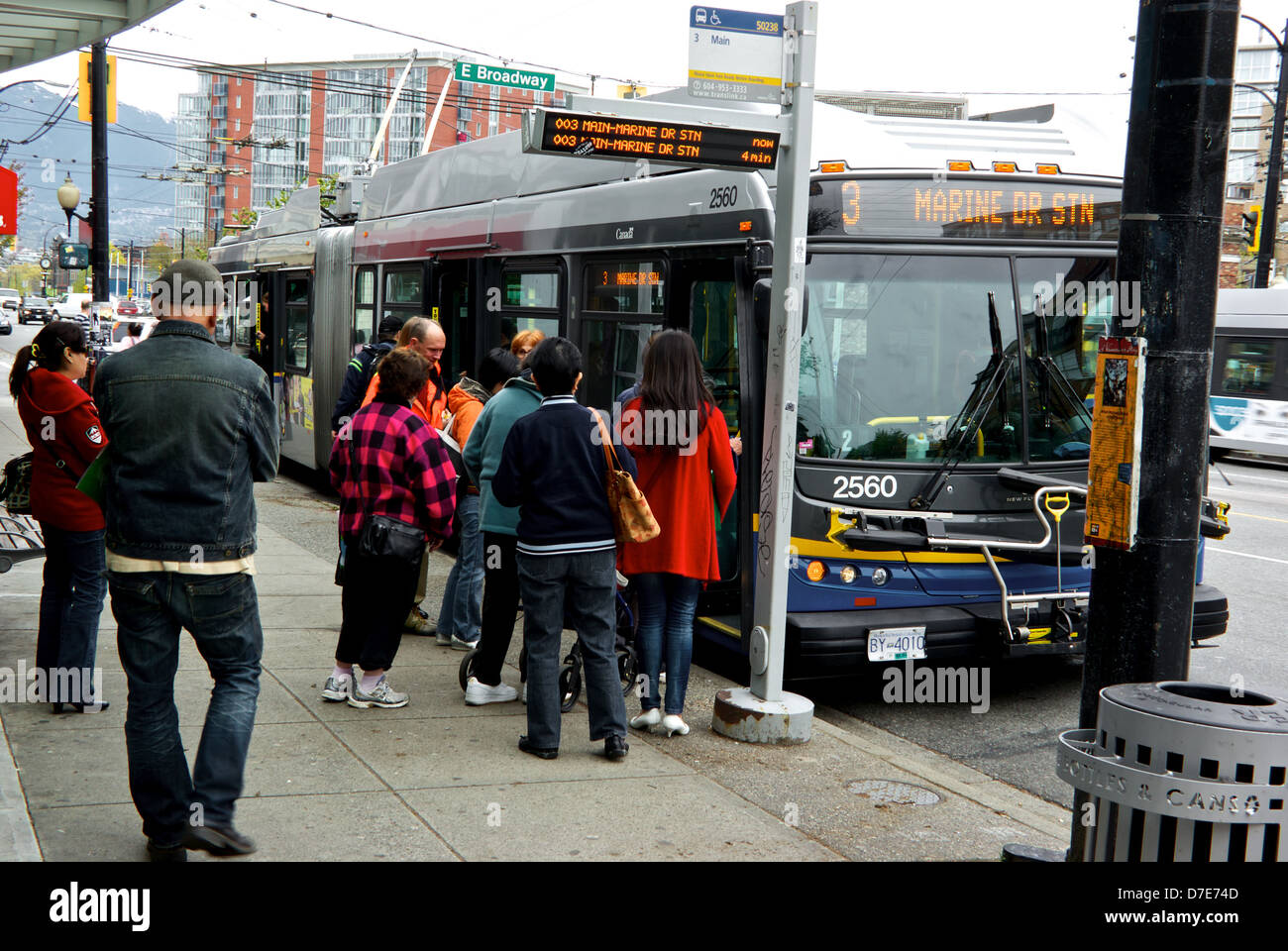 Passengers boarding 3 Main Street articulated electric trolley bus at