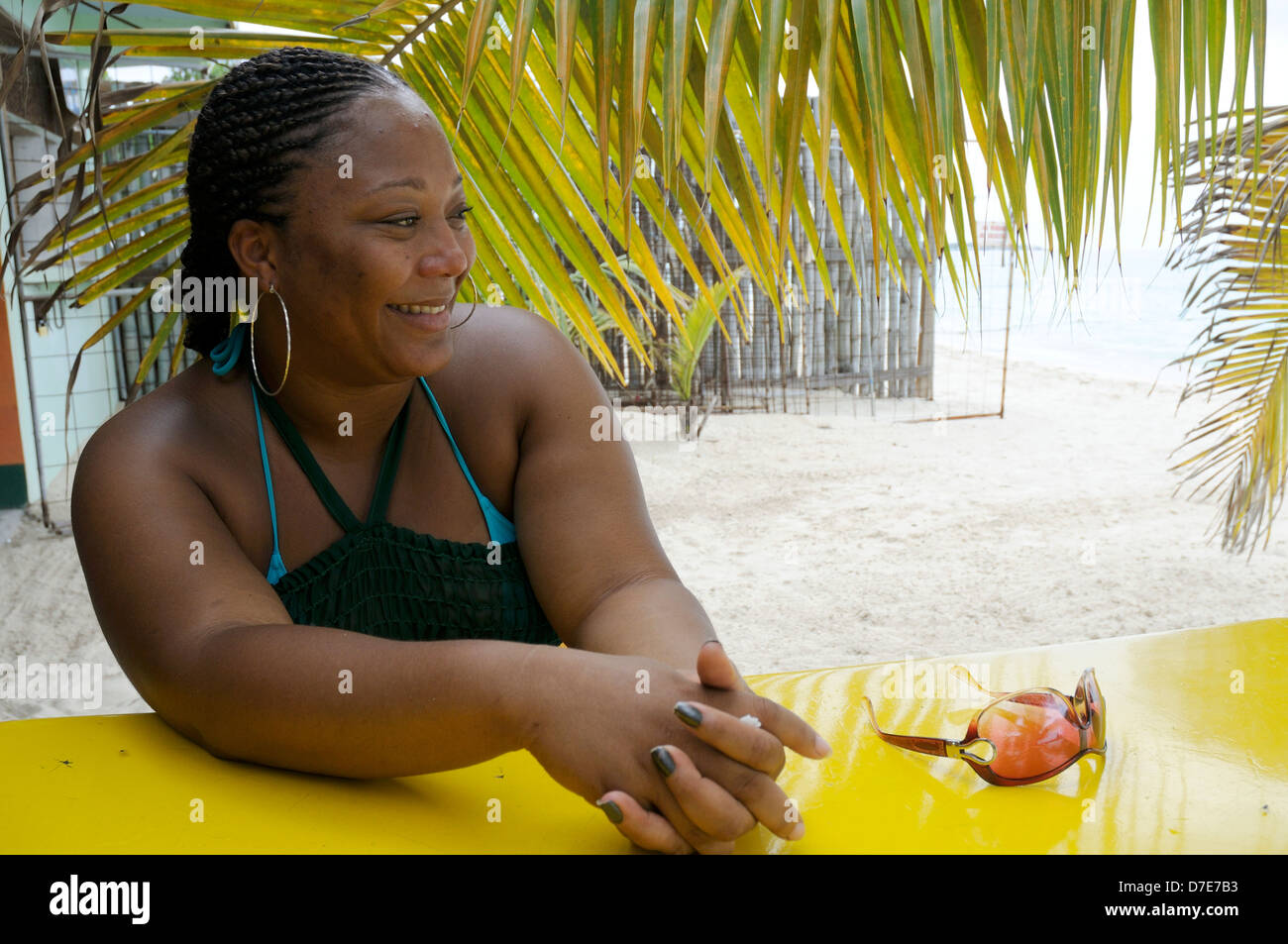 Jamaican Woman Sitting at Negril Beach Restaurant/Bar (MR) Stock Photo