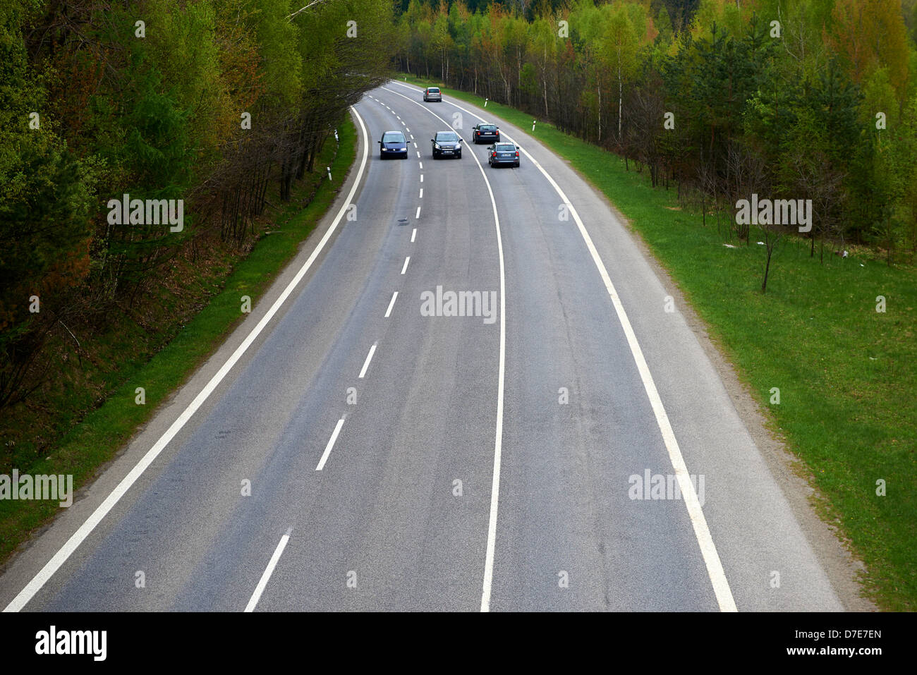 View of car traveling on curved road Stock Photo