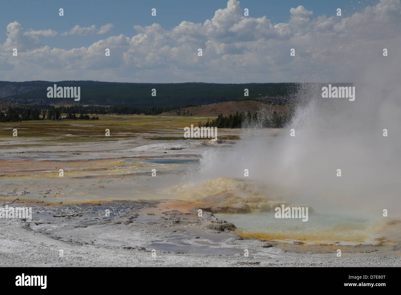 Blue sky white clouds view hot water steam erupting from colourful cone ...