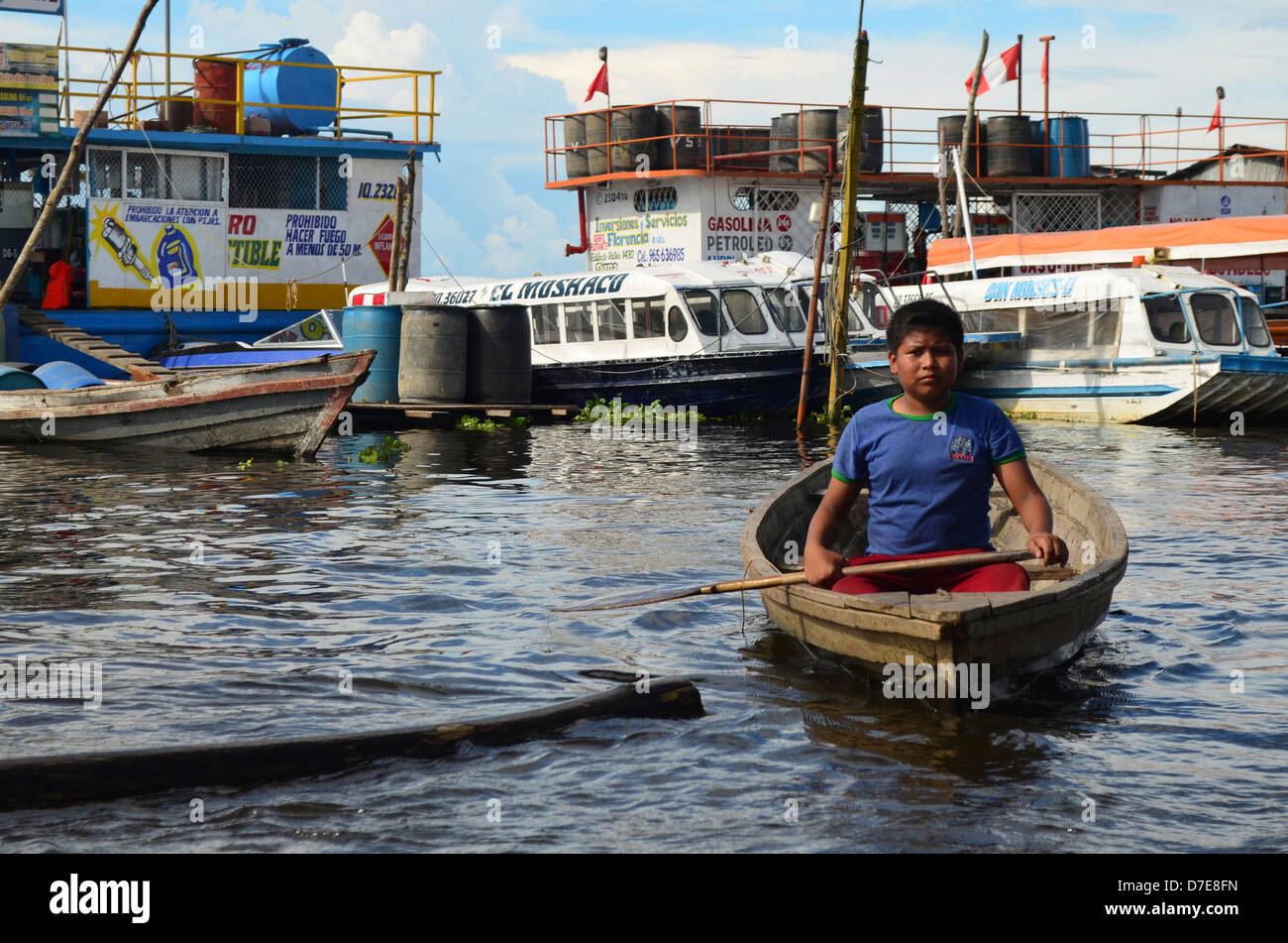 A boy paddles through the Amazon river port of Bellavista Nanay, in Iquitos, Peru. Stock Photo