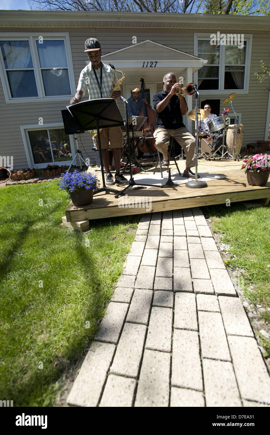 Ann Arbor, Michigan, USA. 5th May 2013. Legendary jazz  trumpeter Marcus Belgrave,76, performs on his front porch during the Water Hill Neighborhood Music Festival in Ann Arbor, MI on May 5, 2013.  On tenor sax is University of Michigan freshman Stephen Grady, on bass Robert Hurst, on piano Ian Finkelstein, and on percussion is Pepe Espinosa. (Credit Image: Credit:  Mark Bialek/ZUMAPRESS.com/Alamy Live News) Stock Photo