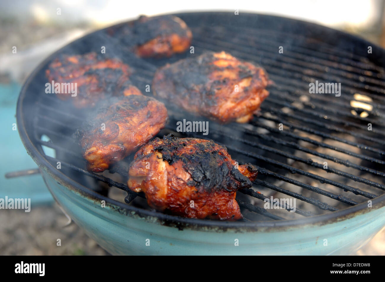 Charcoal barbecue BBQ chicken cooking with burnt skin Stock Photo Alamy