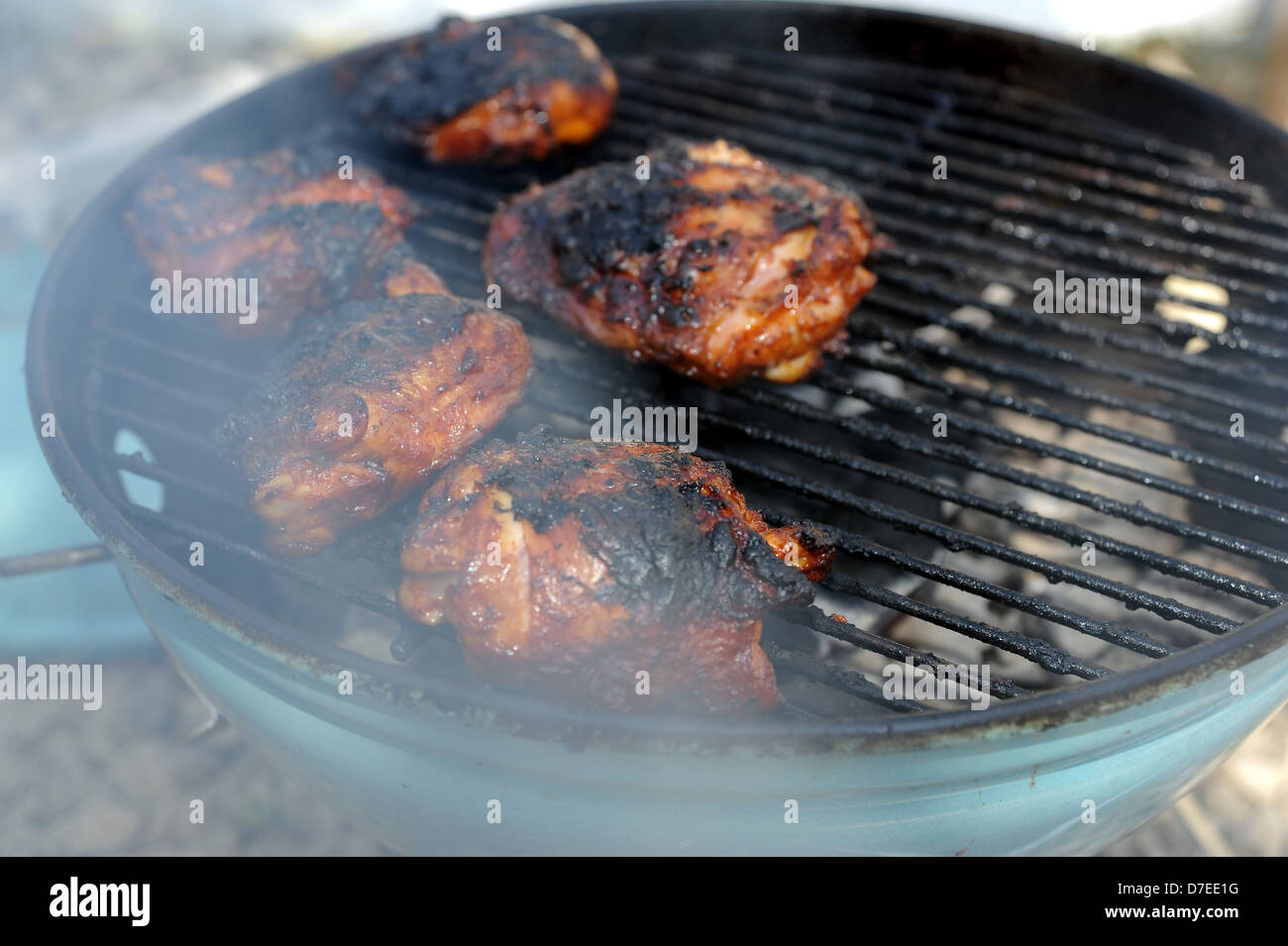 Charcoal barbecue BBQ chicken cooking with burnt skin Stock Photo Alamy