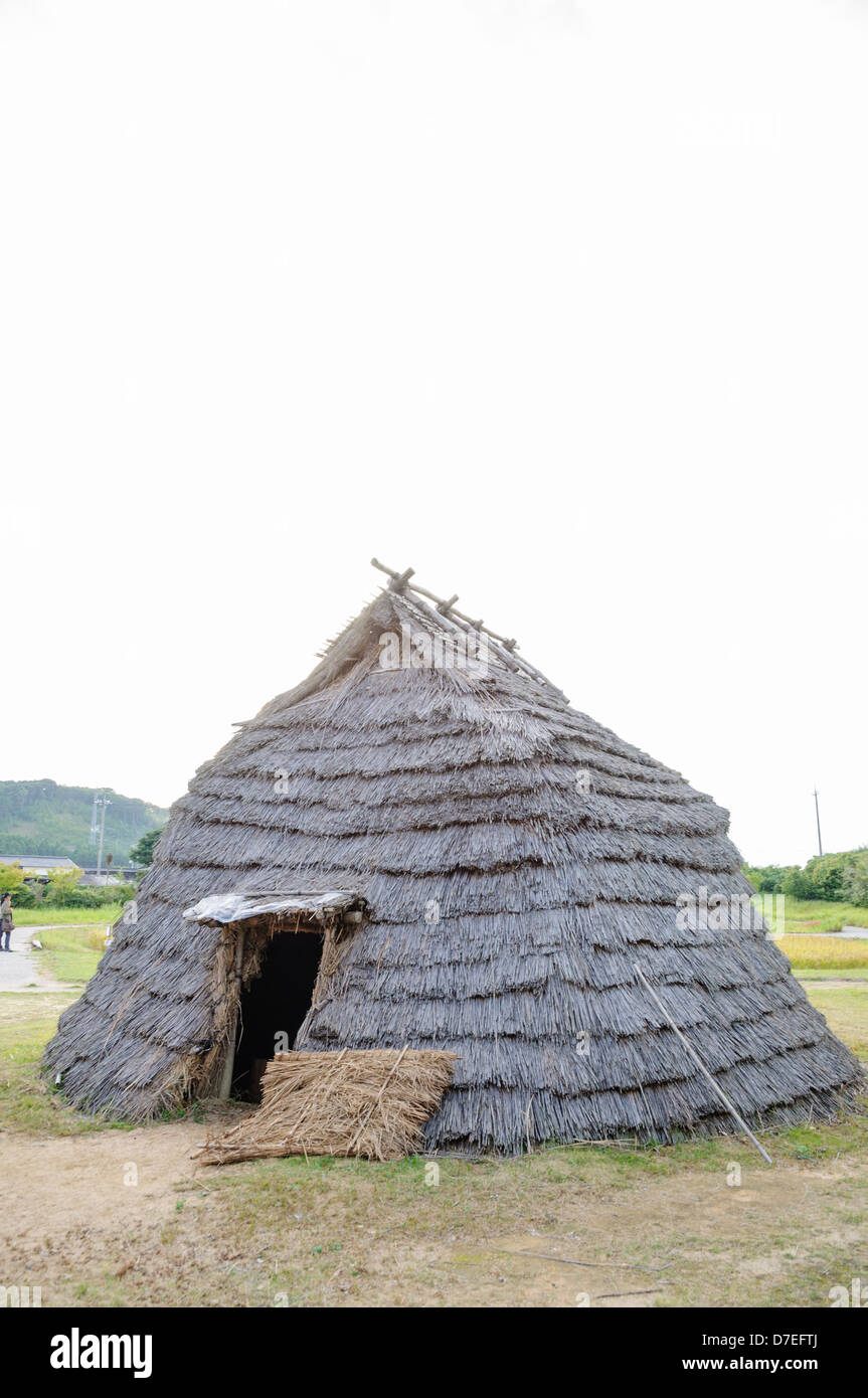 Replica of an ancient Asian straw house. Stock Photo