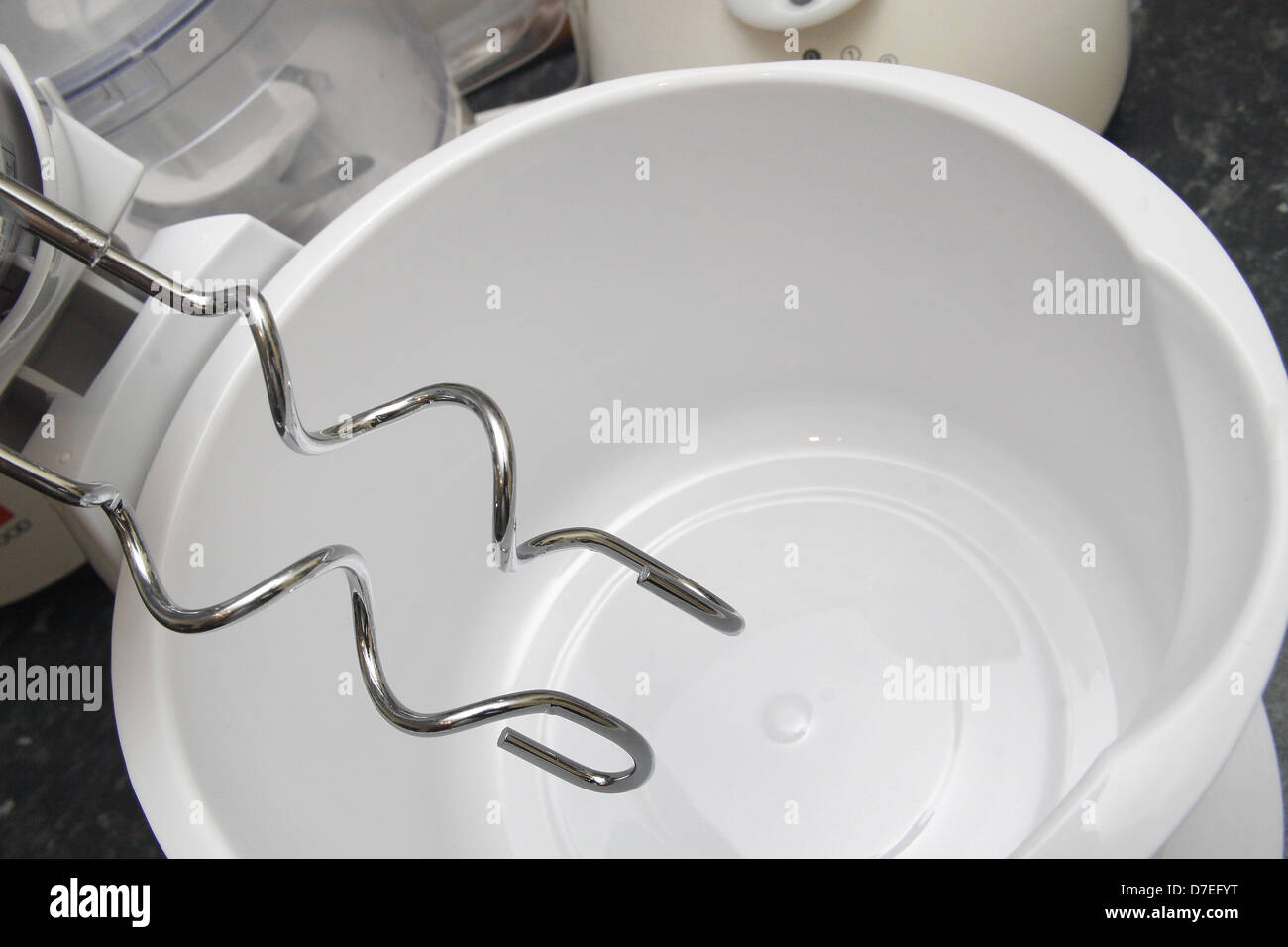 stainless steel dough hooks on white mixing bowl Stock Photo