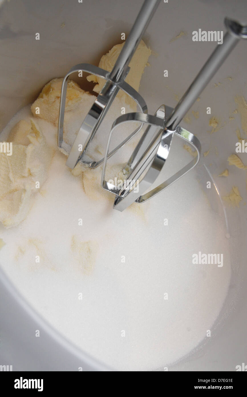 stainless steel mixers creaming sugar and butter in white mixing bowl Stock Photo Alamy