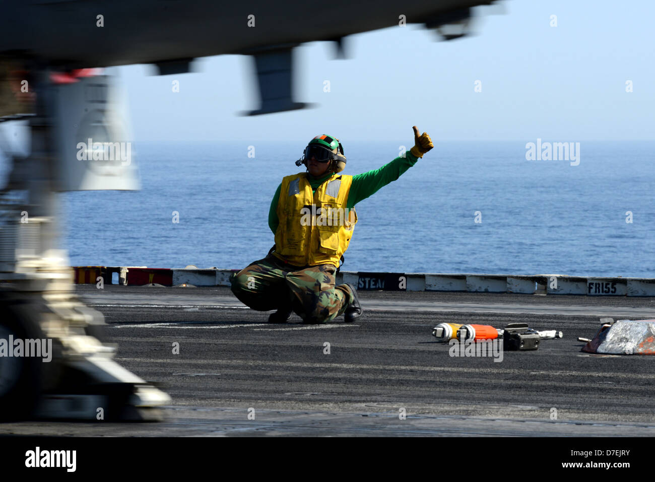 A Sailor signals for an aircraft to launch Stock Photo - Alamy