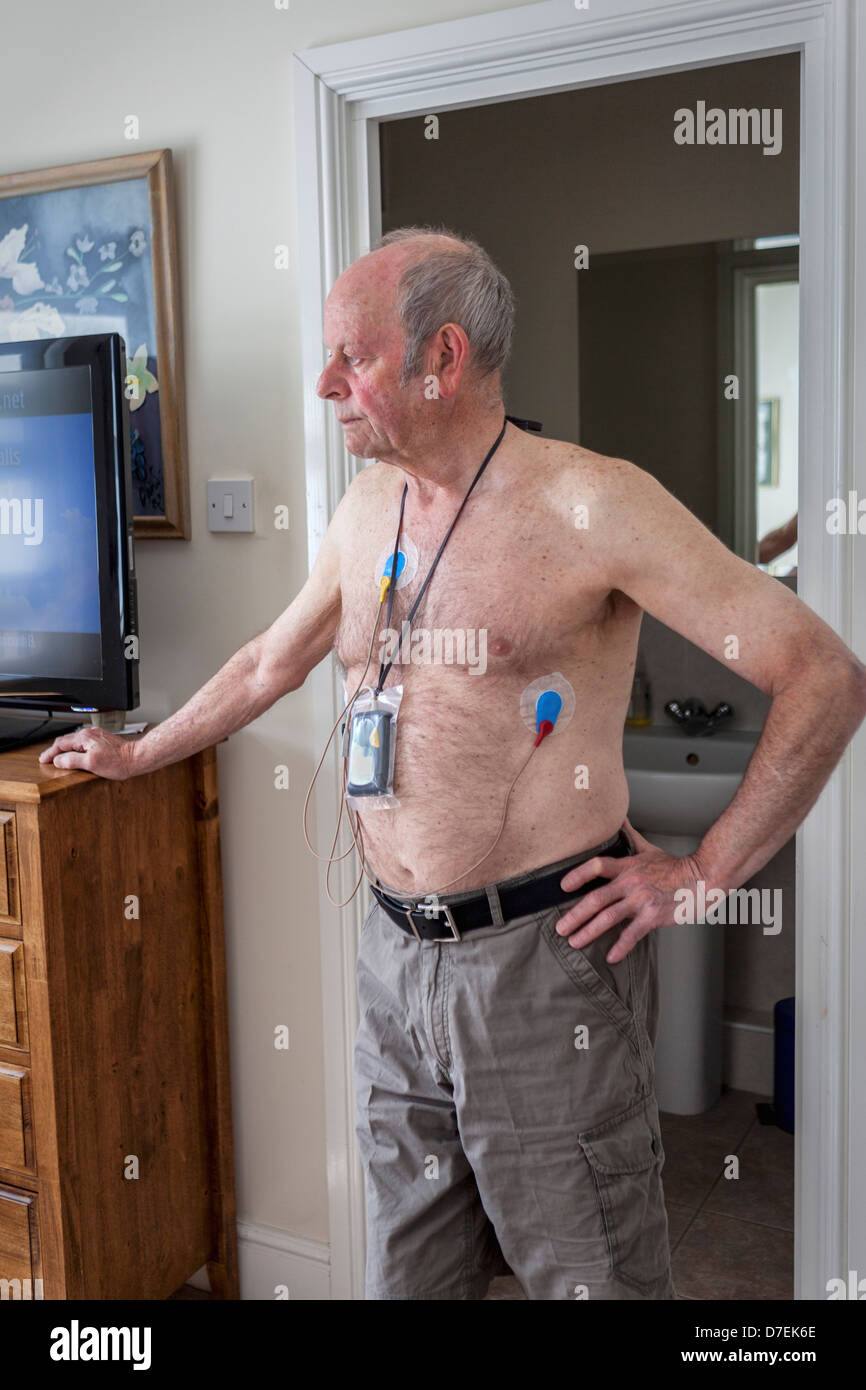 Senior man wearing portable 24-hour cardiac monitor at home Stock Photo -  Alamy