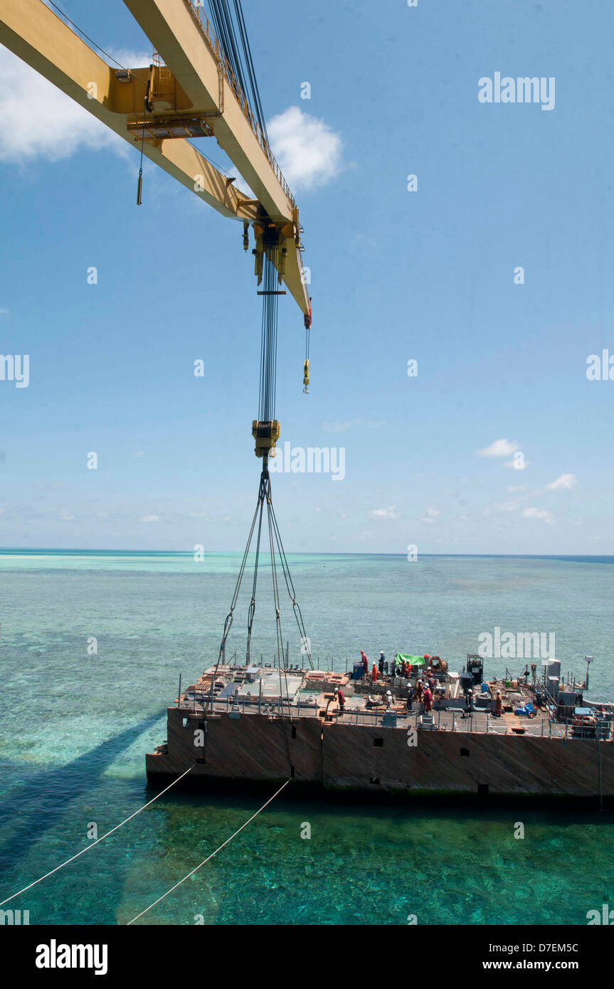 A crane vessel prepares to lift a hull section of the former USS Guardian. Stock Photo