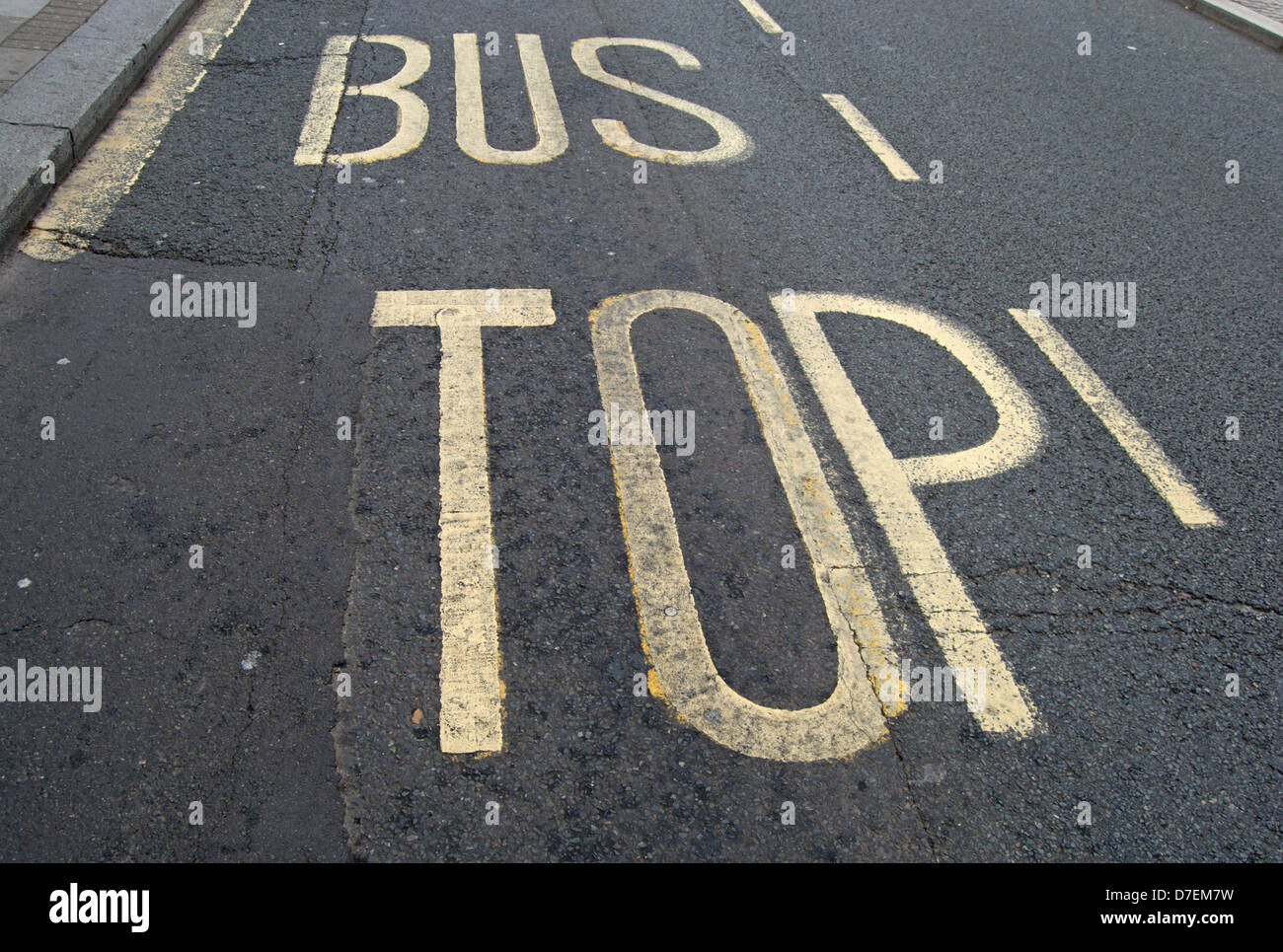 british road marking indicating a bus stop but with the letter s obscured due to a new road surface Stock Photo