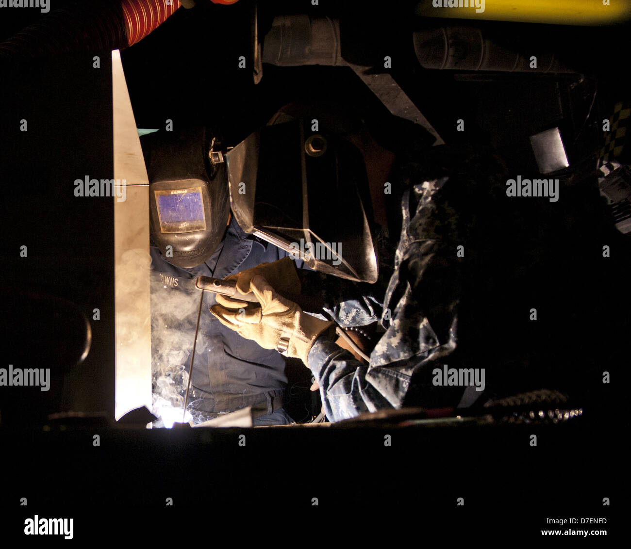 Sailors make metal shelves abord USS Carl Vinson. Stock Photo