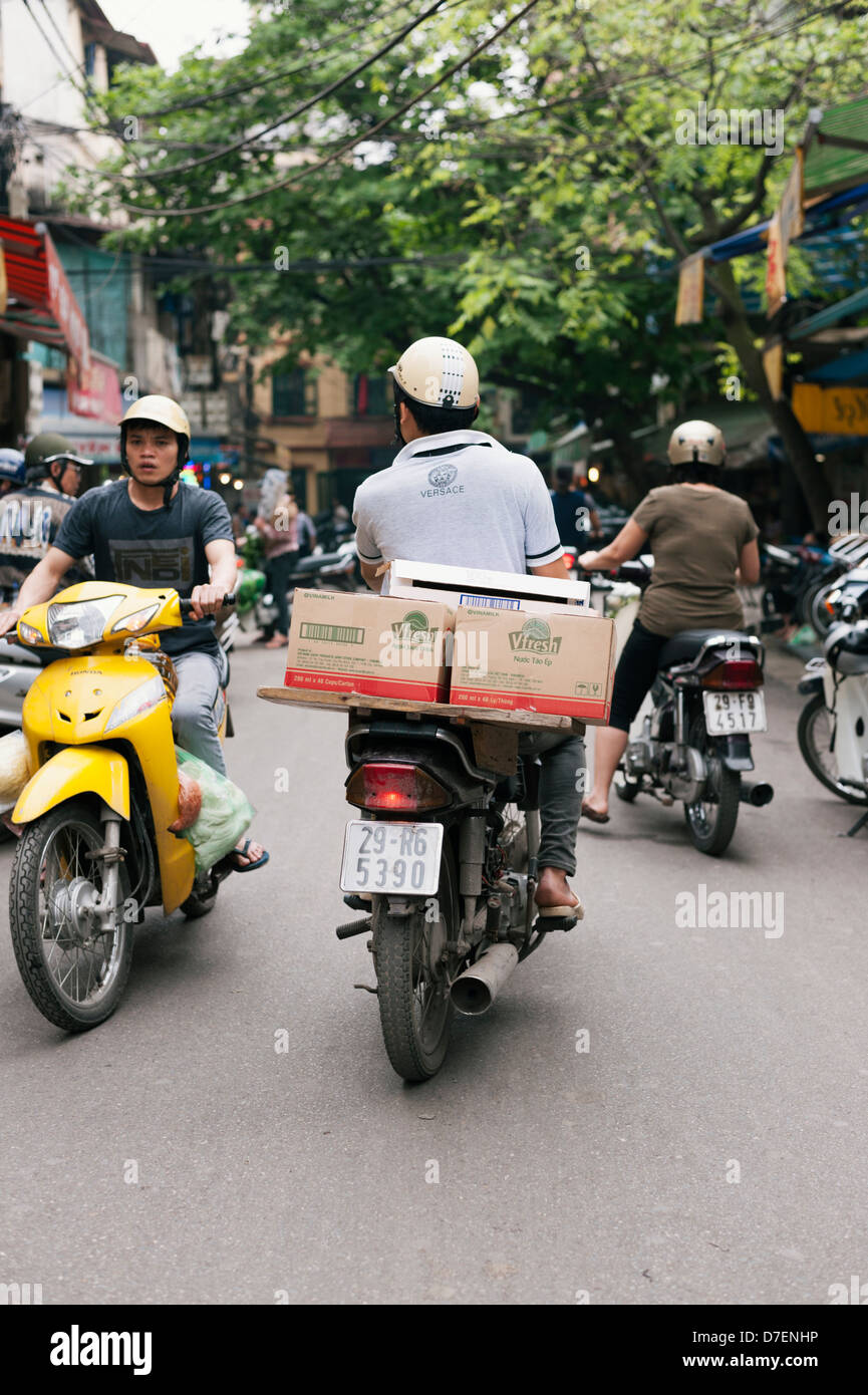 Hanoi, Vietnam - scooter traffic on the busy streets of the historic Old Quarter Stock Photo