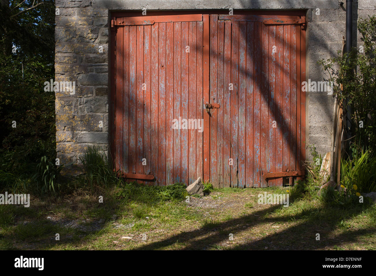 Padlocked Peeling Garage Doors Of An Old Stone Garage In A