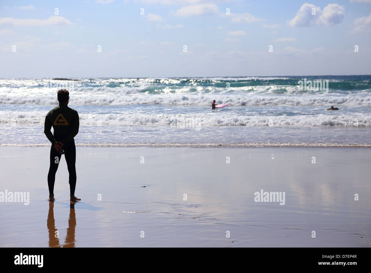 Surfer looking at the sea, Amado beach, Costa Vicentina, Portugal Stock Photo