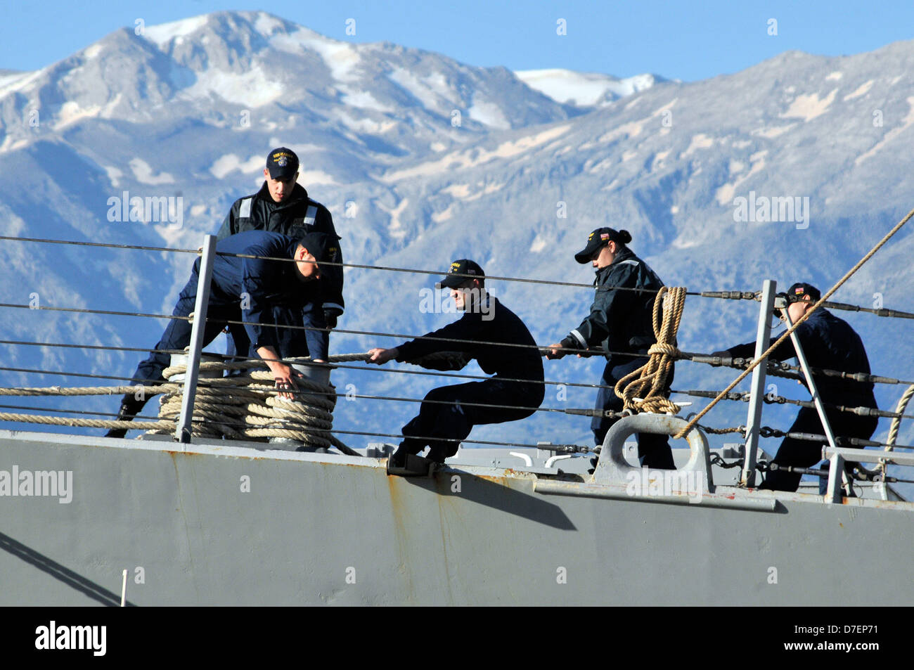 Sailors handle mooring lines. Stock Photo