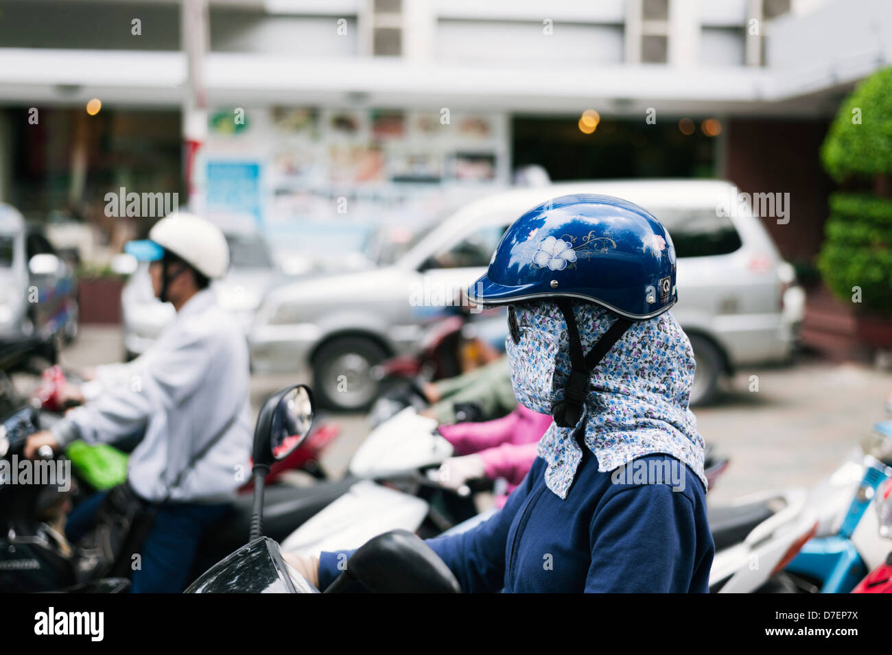 Ho Chi Minh City, Vietnam - a woman wearing a face mask & sun ...
