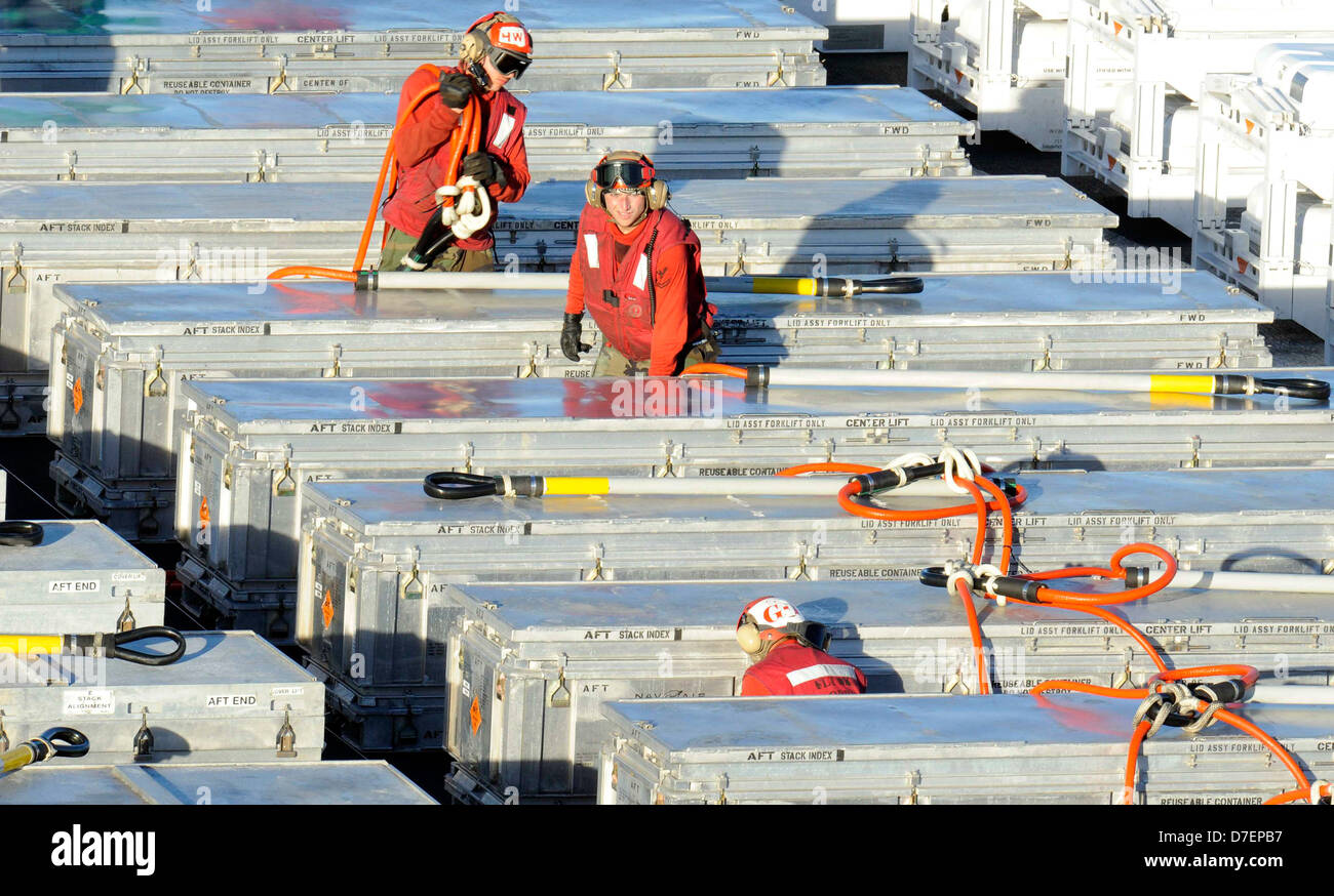 Sailors offload ordnance. Stock Photo
