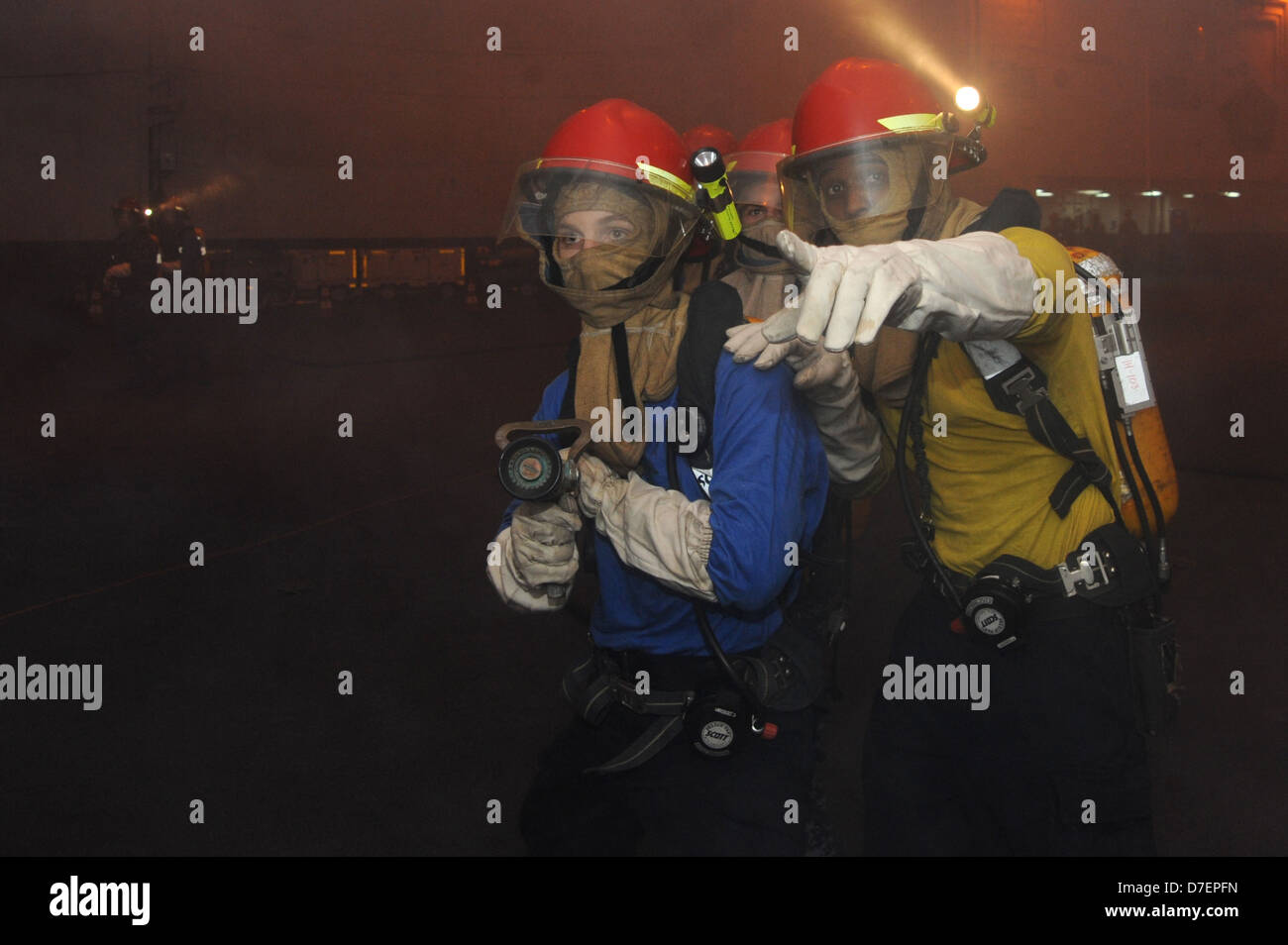 Sailors conduct a firefighter drill. Stock Photo