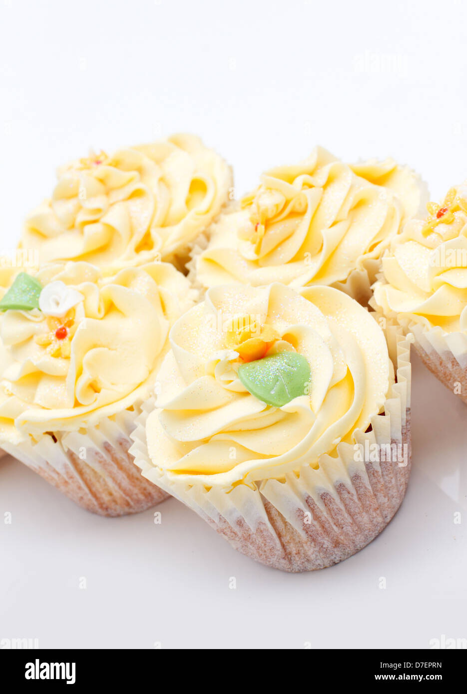 homemade creamy luxury cup cakes with detailed flower and sparkles Stock Photo