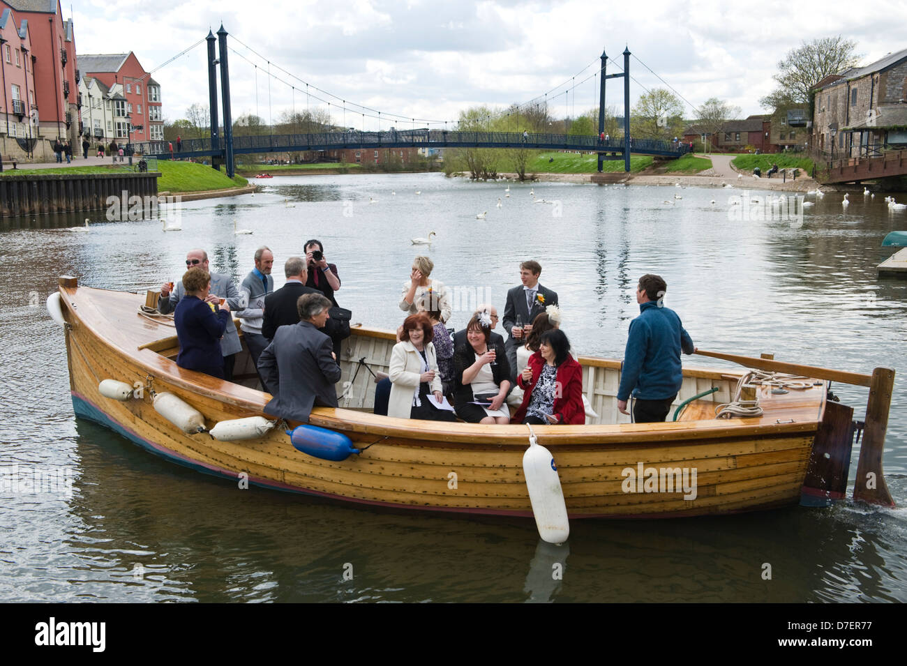 Wedding party in boat setting off from the quay in Exeter Devon England