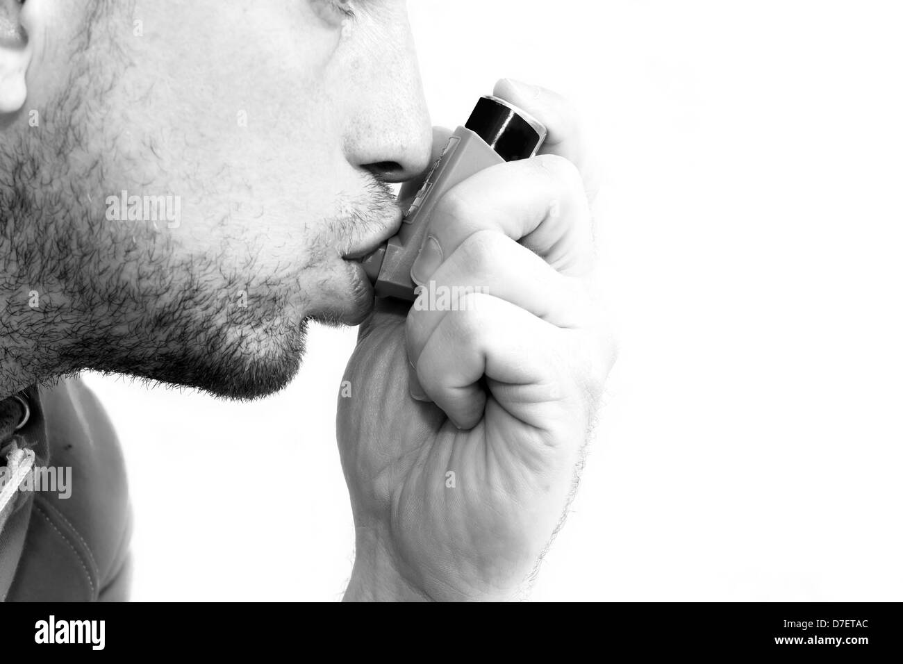 man inhaling his asthma pump Stock Photo