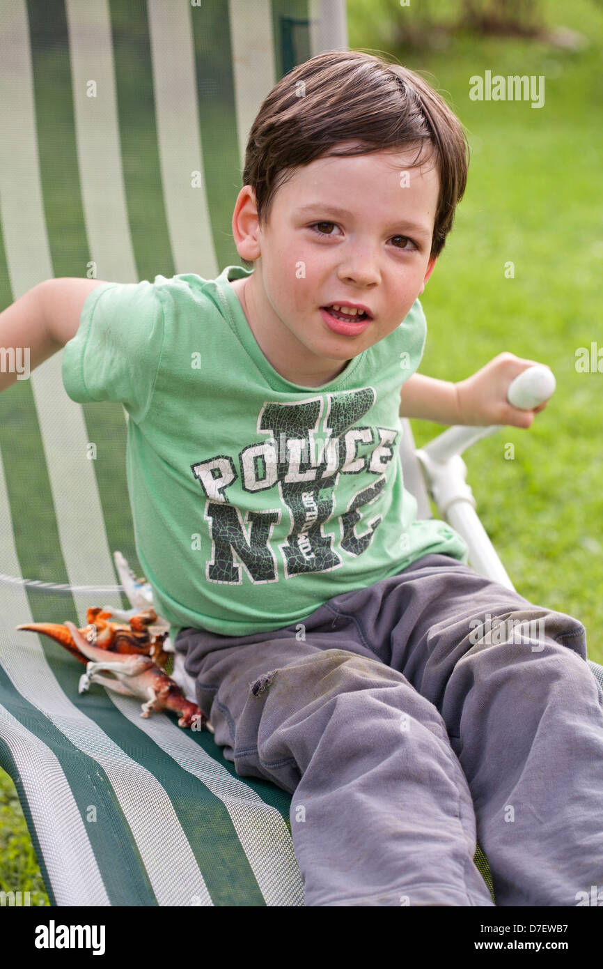 Boy playing on a lounger. Stock Photo