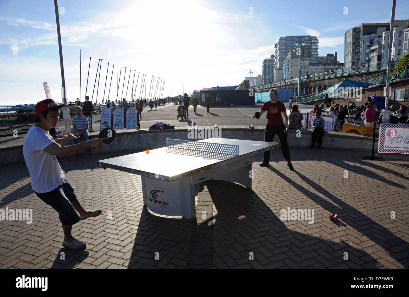 Brighton UK 6th May 2013 - Playing table tennis as the sun goes down on Brighton seafront after a long hot day on during the May Bank Holiday Monday  Photograph taken by Simon Dack/Alamy Live News Stock Photo