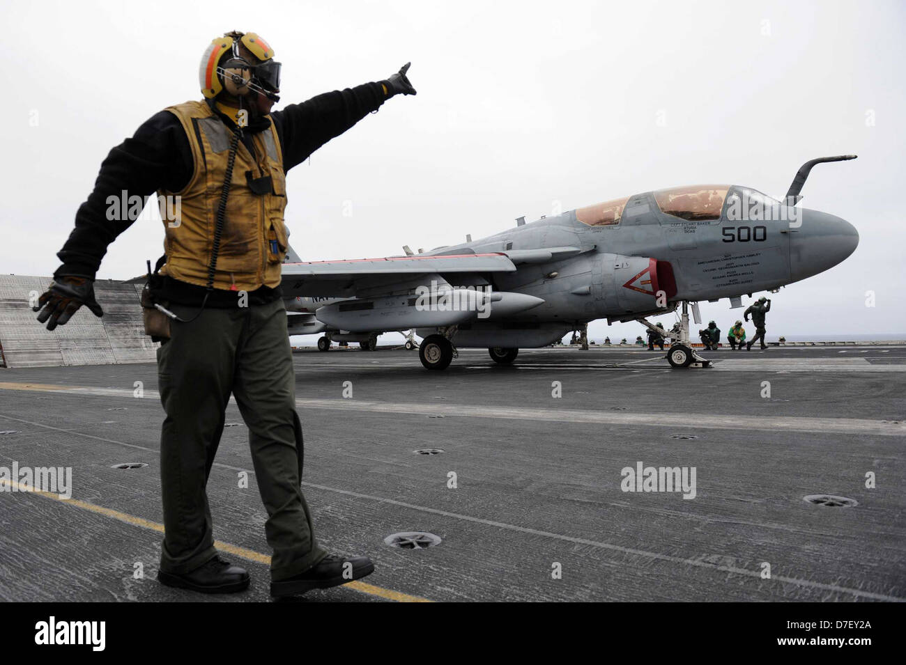 A Sailor directs an EA-6B Prowler. Stock Photo