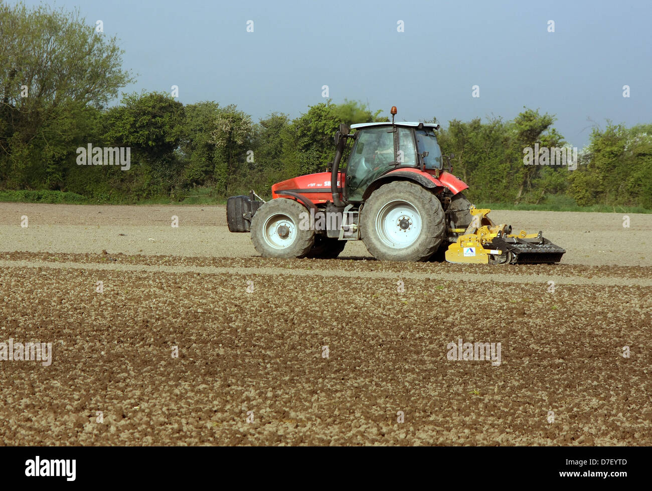 Farmer taking advantage of the fine weather to work his land on a Sunday, May 2013 Stock Photo