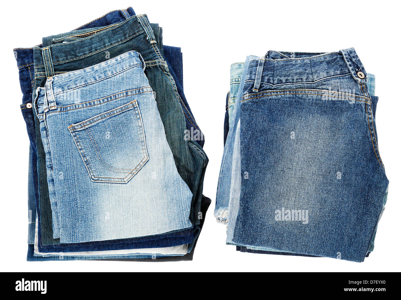 Two stacks of various pairs of jeans pants isolated on white background ...