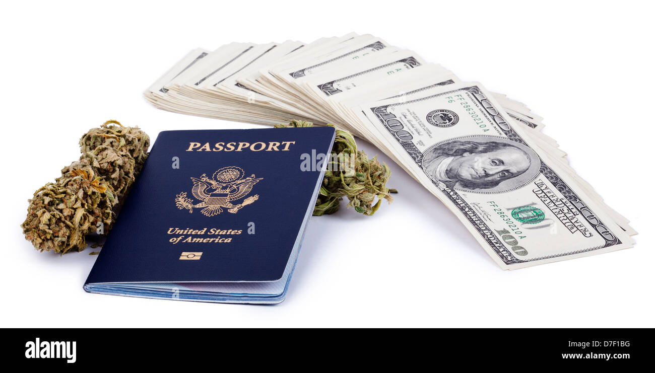 A USA passport, a marijuna bud and a large stack of 100 US dollar money notes isolated on white background. Stock Photo