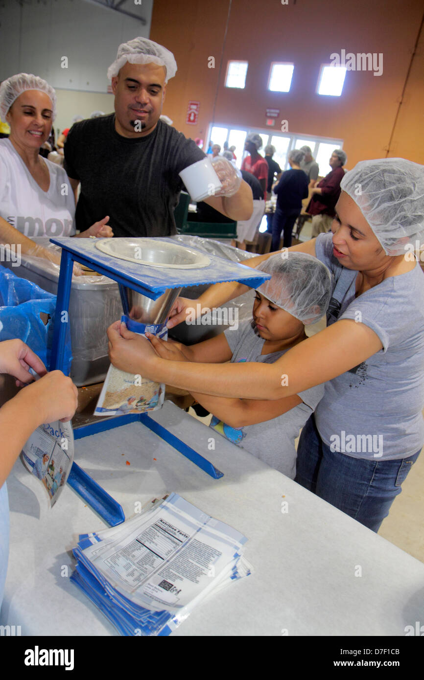 Miami Florida,Miami Dade County Fair & Expo,Feed My Starving Children,volunteer volunteers volunteering work worker workers,working together serving h Stock Photo