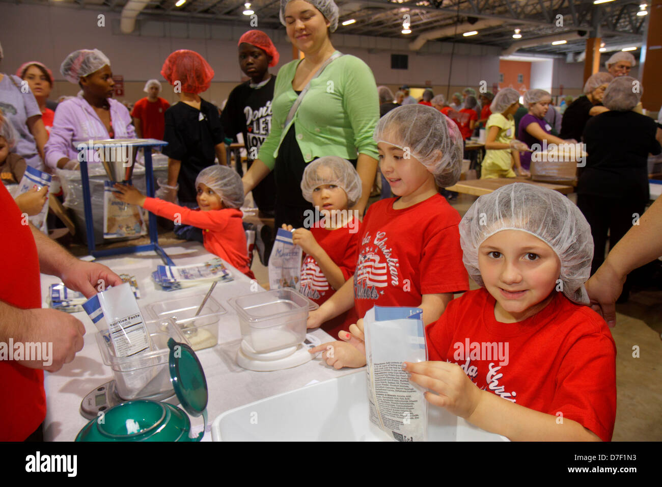 Miami Florida,Miami Dade County Fair And Expo,Feed My Starving Children,volunteer volunteers community service volunteering work worker workers,teamwo Stock Photo