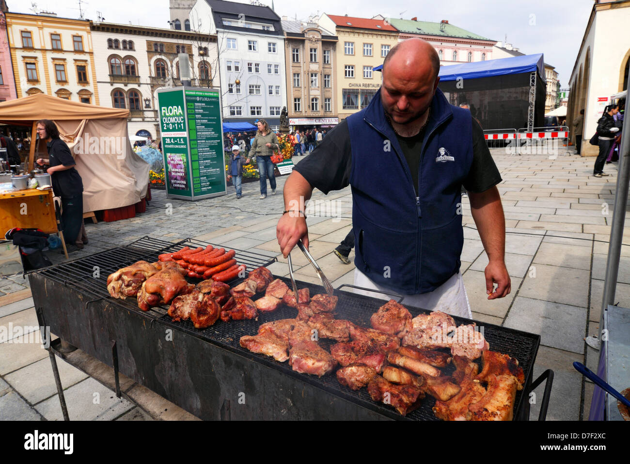 Czech cook preparing grill meat in Olomouc Square celebrating May 1 Stock Photo