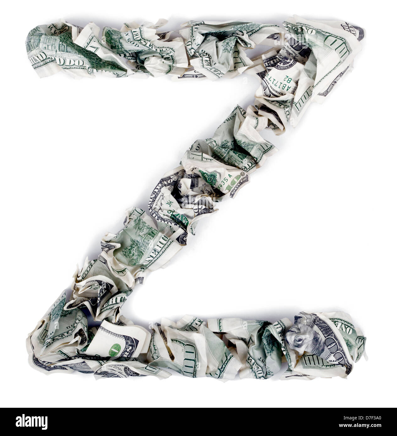 The letter 'z' made out of crimped 100$ bills. Isolated on white background. Stock Photo