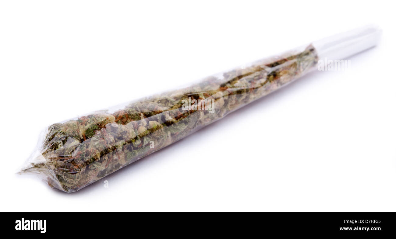 A marijuana joint rolled with transparent rolling paper, ready for use. Isolated on white. Stock Photo