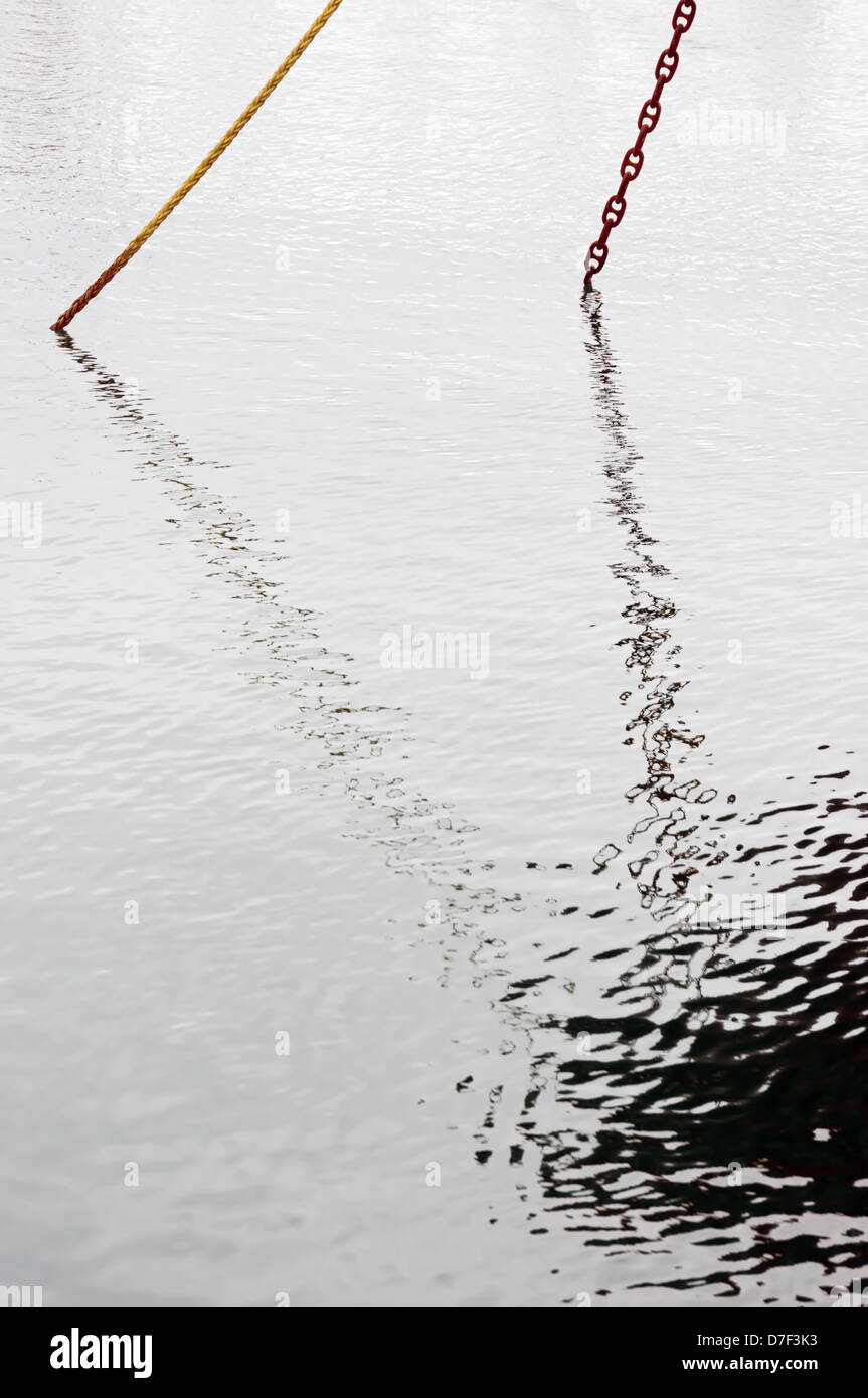 refections of an anchored ship on water Stock Photo